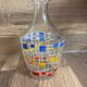 Vintage carafe and its 3 graphic style liqueur glasses.