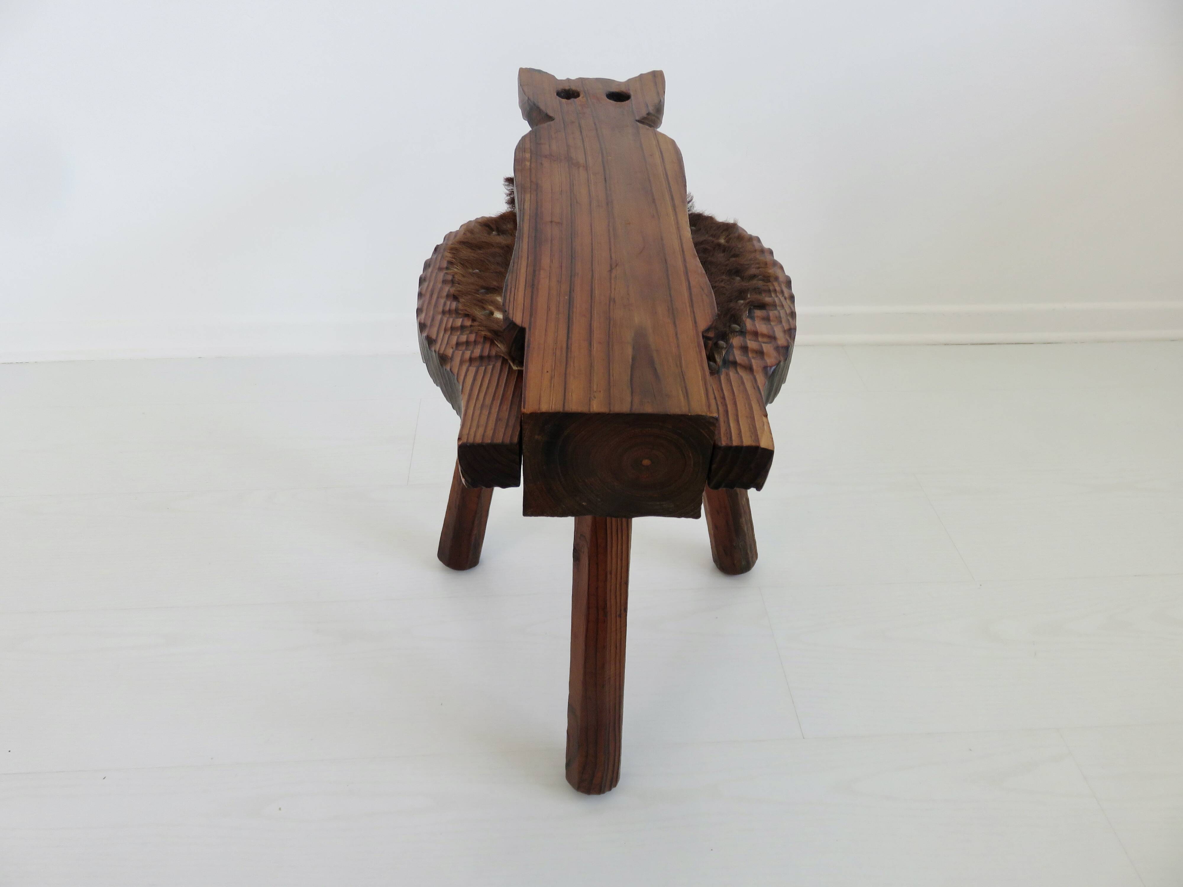 Brutalist cowhide tripod stool in solid wood