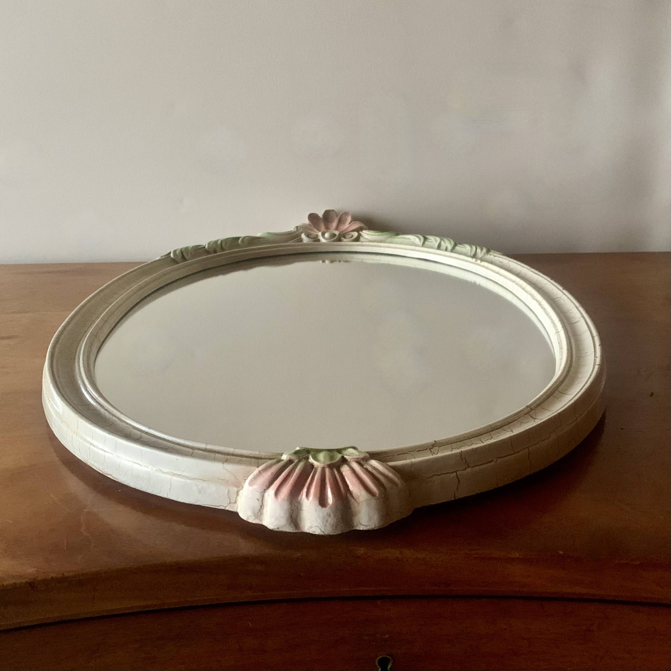 Vintage oval mirror in carved wood in pastel tones