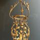Important golden iron lantern with foliage decorations from the Baguès house.