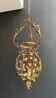 Important golden iron lantern with foliage decorations from the Baguès house.