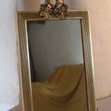 Small rectangular mirror in gilded wood with a pediment decorated with flowers