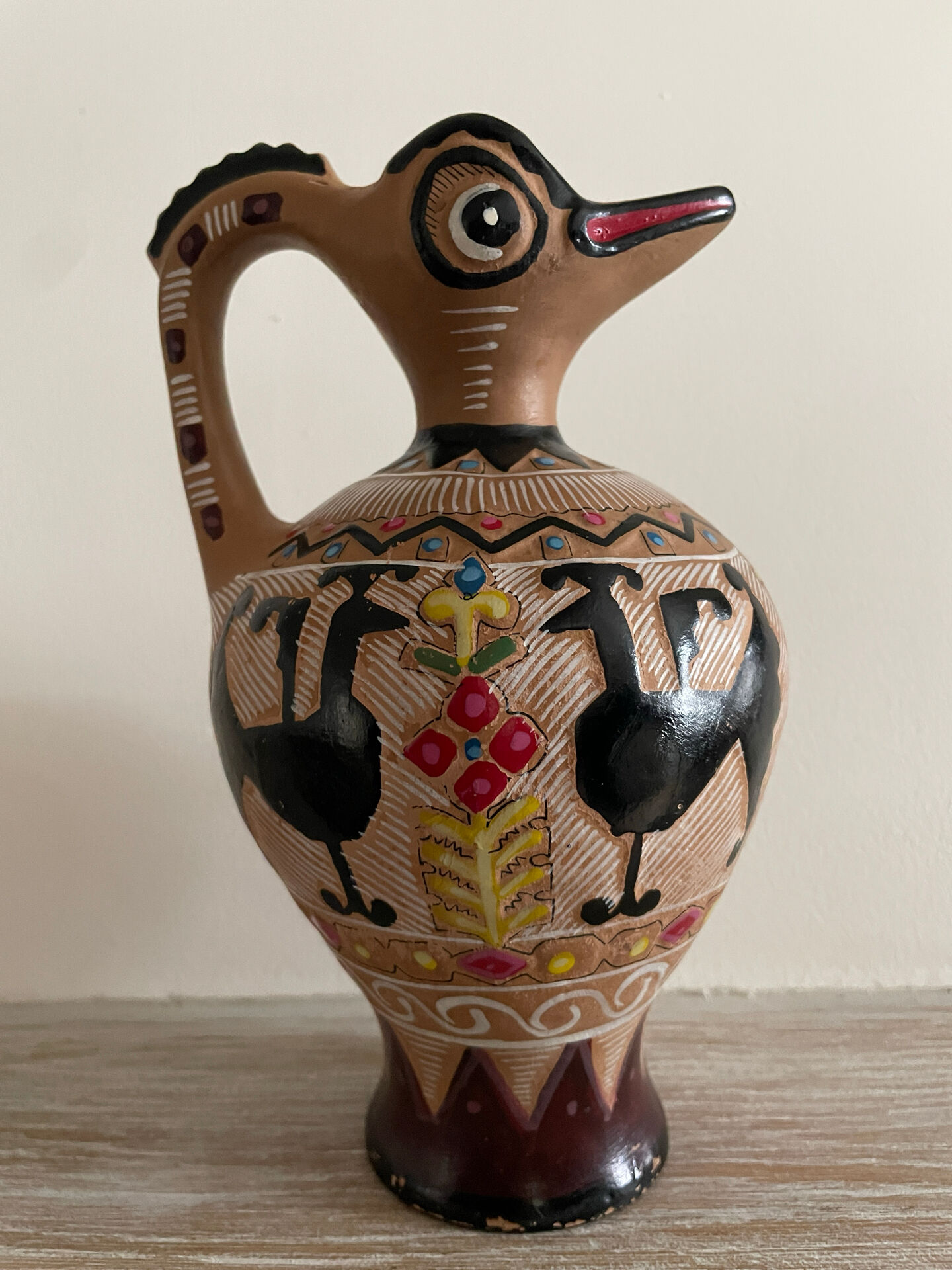 Clay pitcher with a bird head