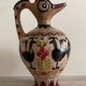 Clay pitcher with a bird head