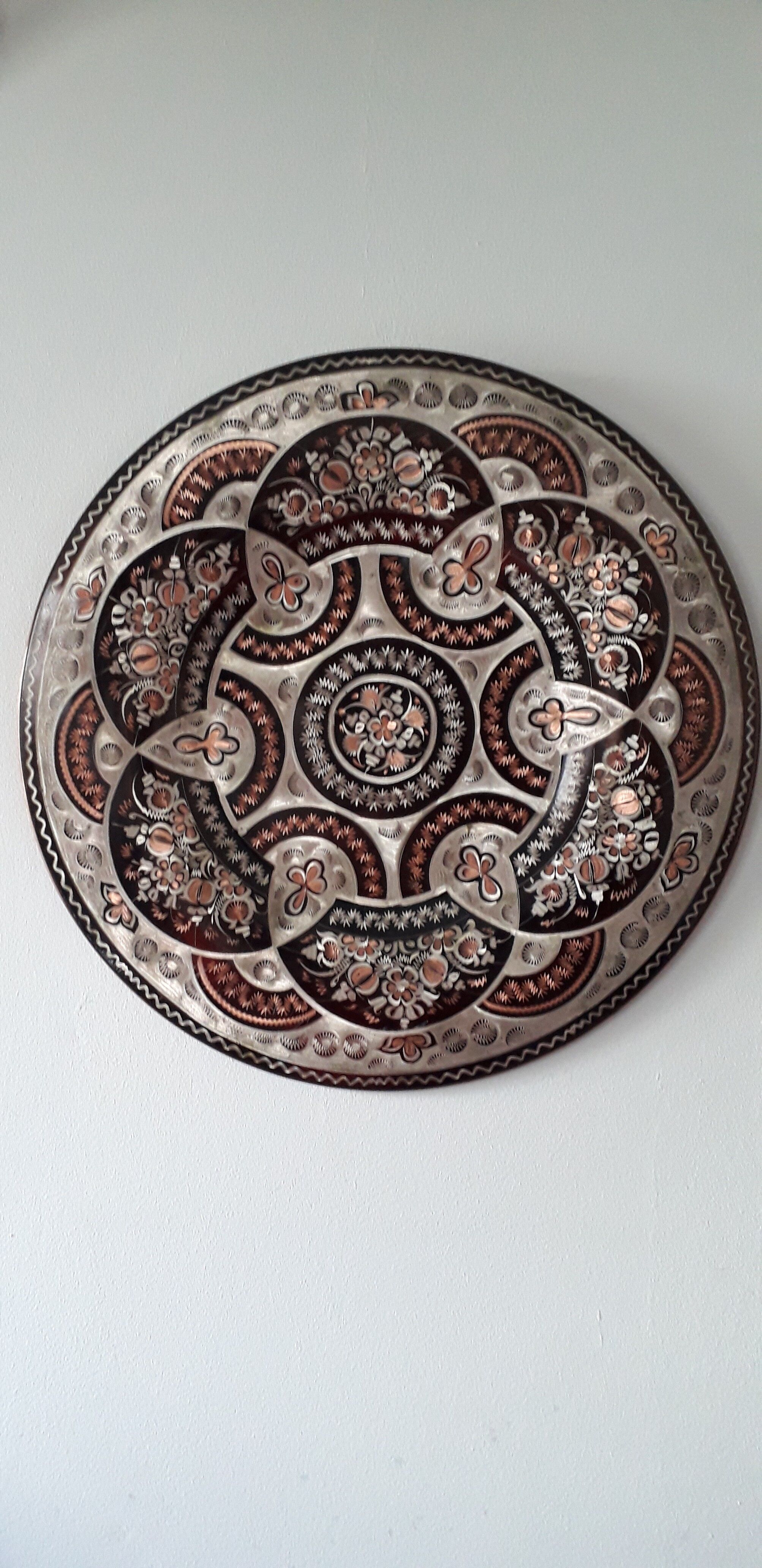 Oriental dish in chiseled red copper