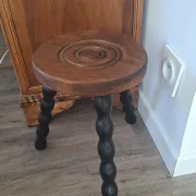 Brown and black wooden tripod stool