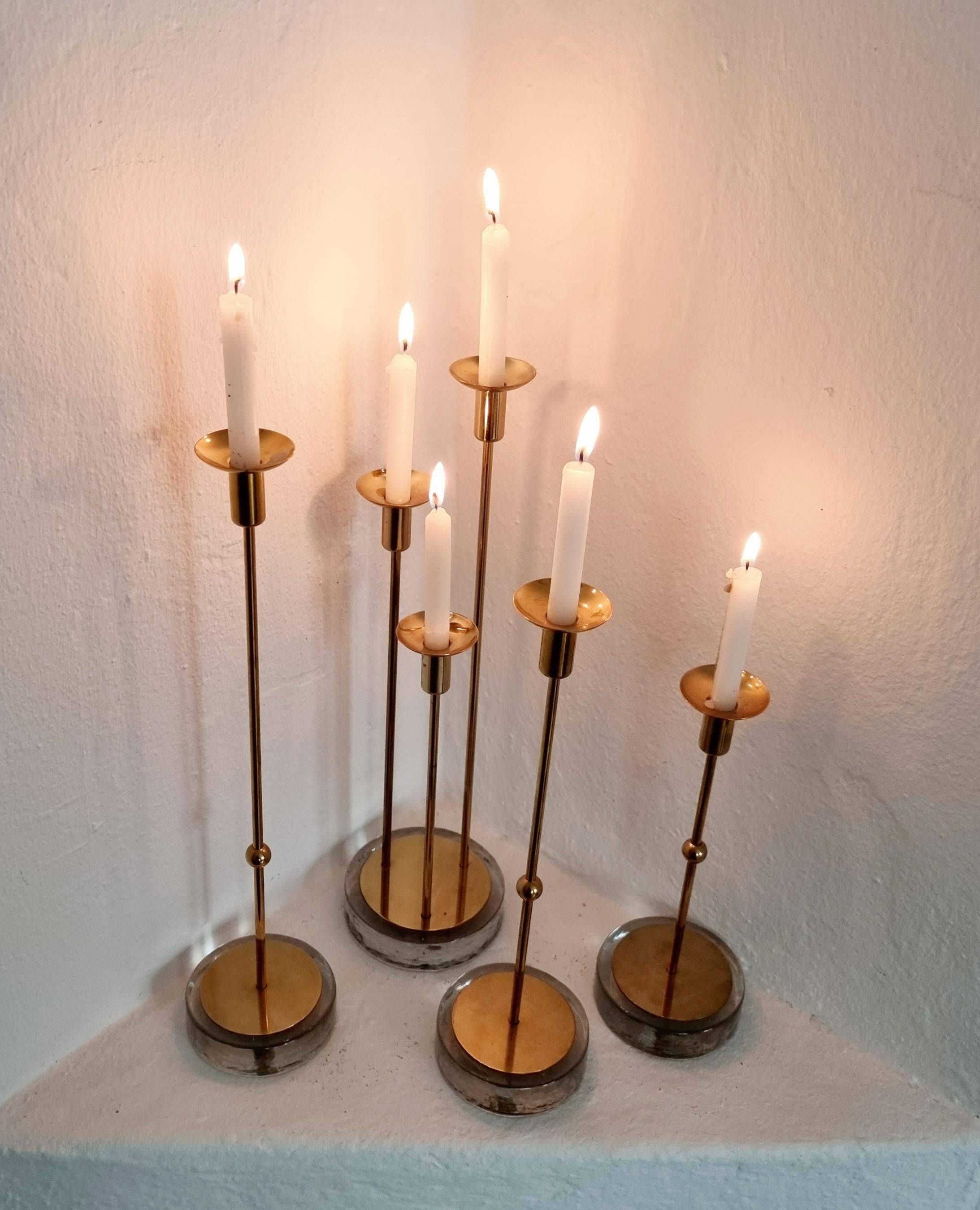 Gunnar Ander, four candlesticks, brass and glass, Ystad Metall, Swedish modern.