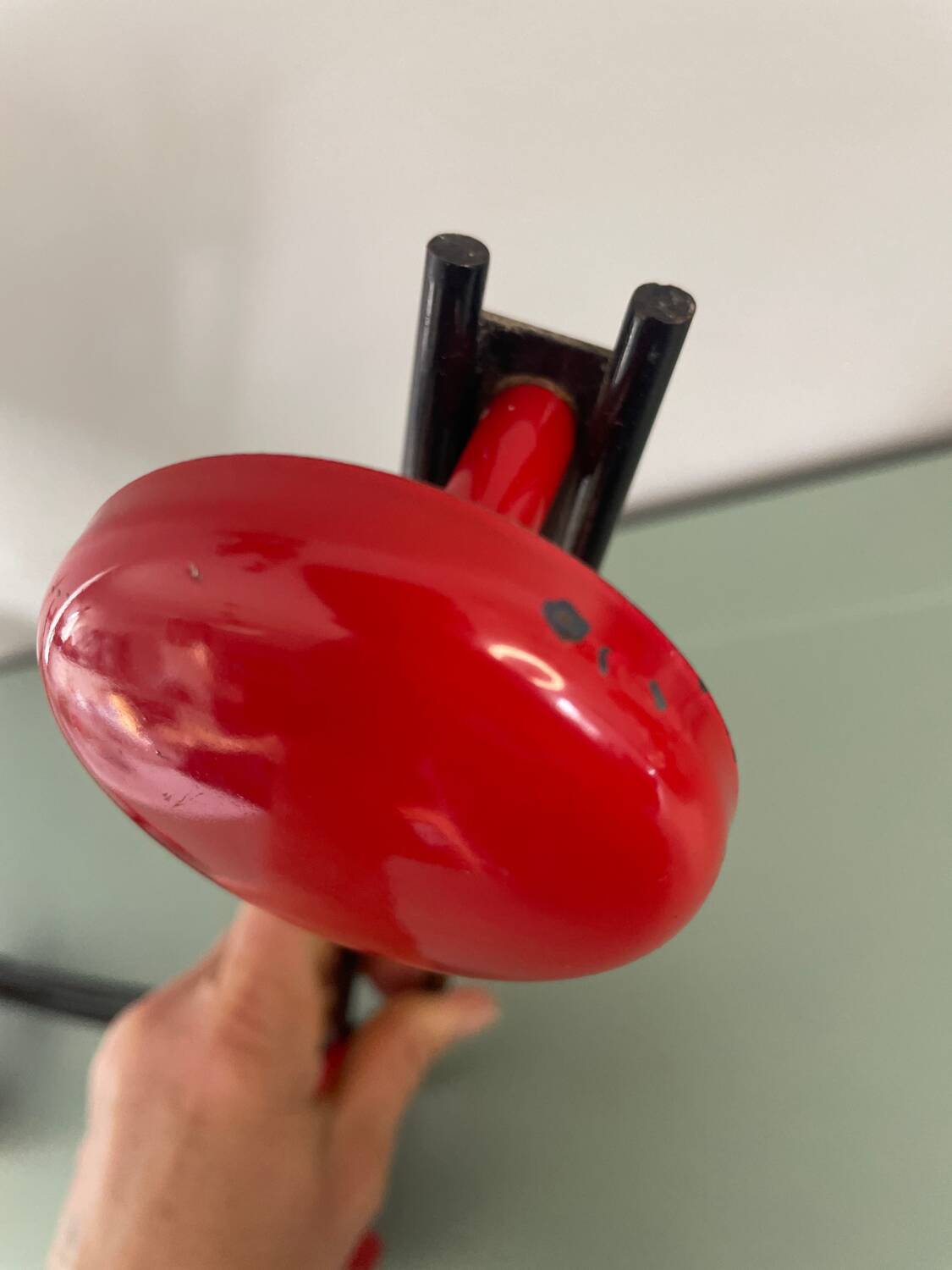 Coat rack, red and black metal hook.