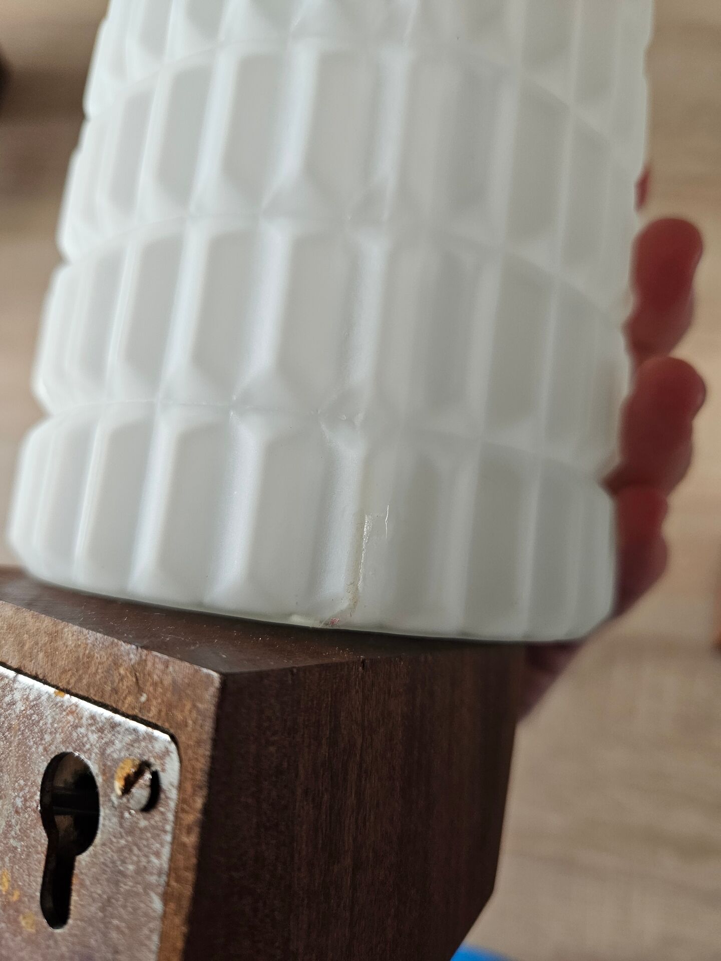 Philips wall sconces in wood and white opal.