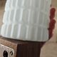 Philips wall sconces in wood and white opal.