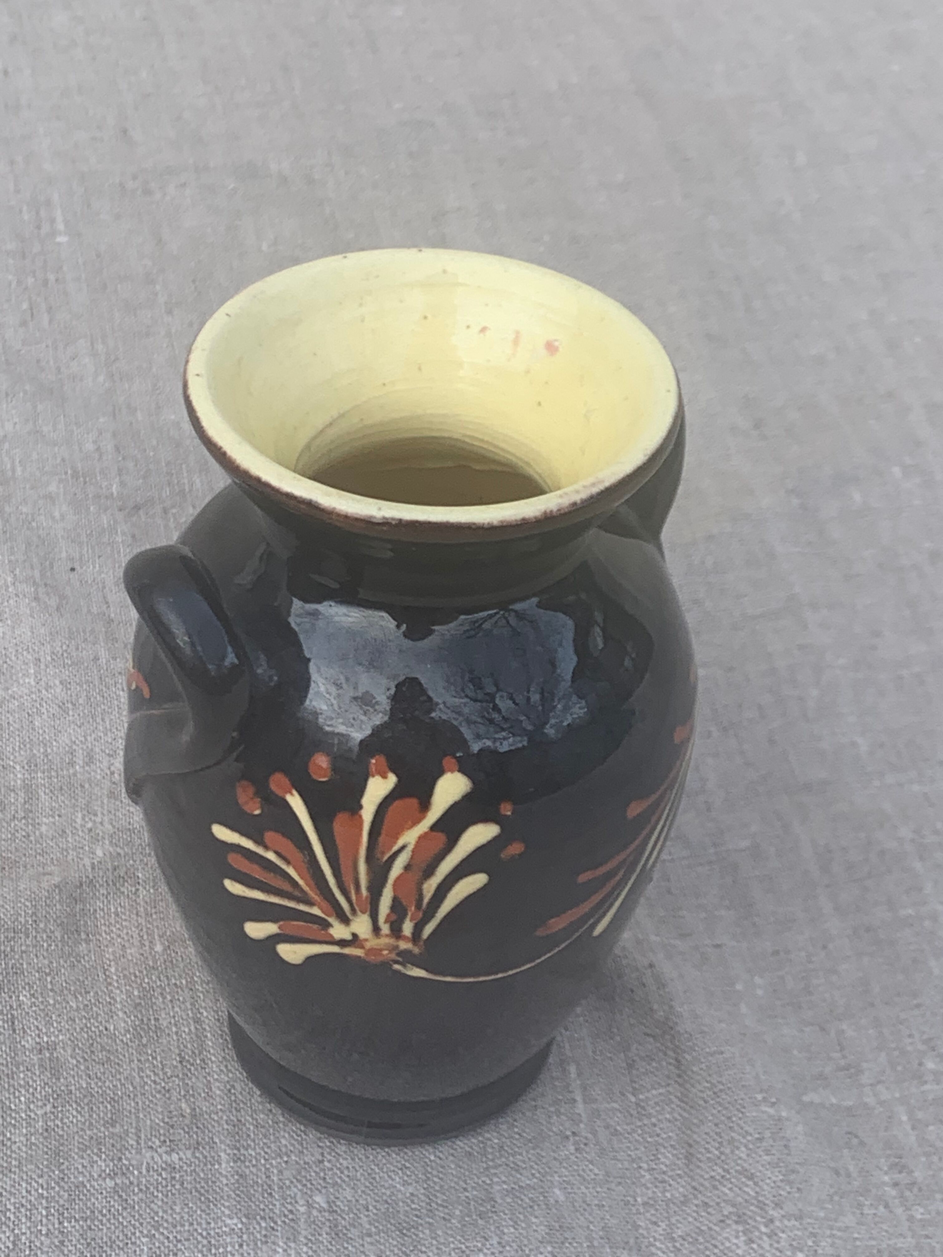 Vintage hand-painted yellow and black glazed ceramic amphora vase
