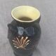 Vintage hand-painted yellow and black glazed ceramic amphora vase
