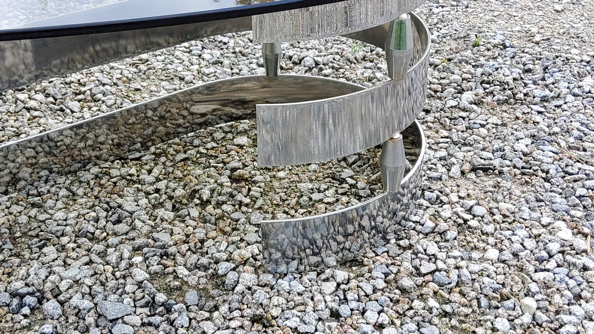 Oval coffee table of the 70s chromed metal base in s smoked glass top