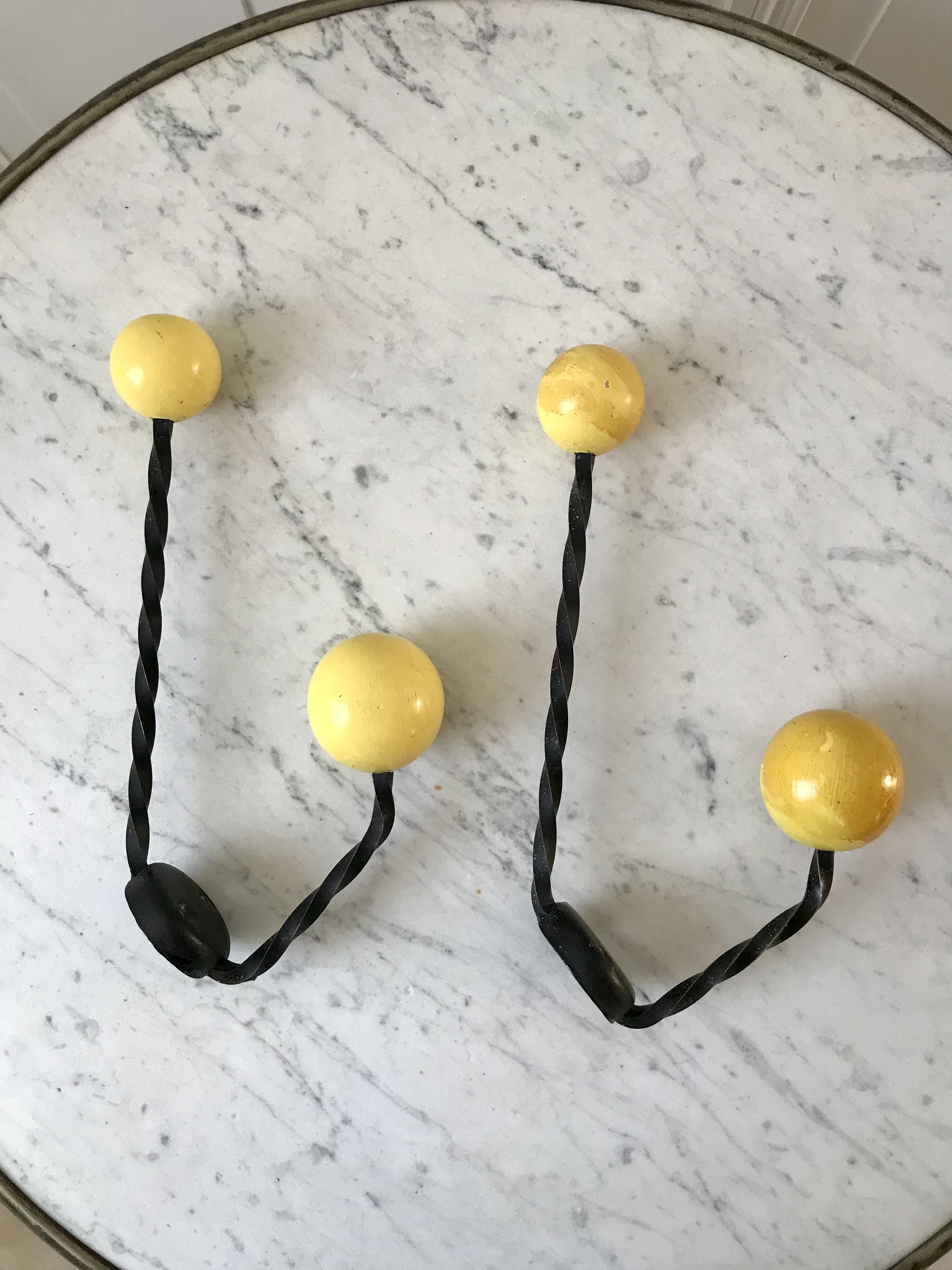 Duo of hooks balls in yellow wood and black iron 60s