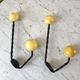 Duo of hooks balls in yellow wood and black iron 60s
