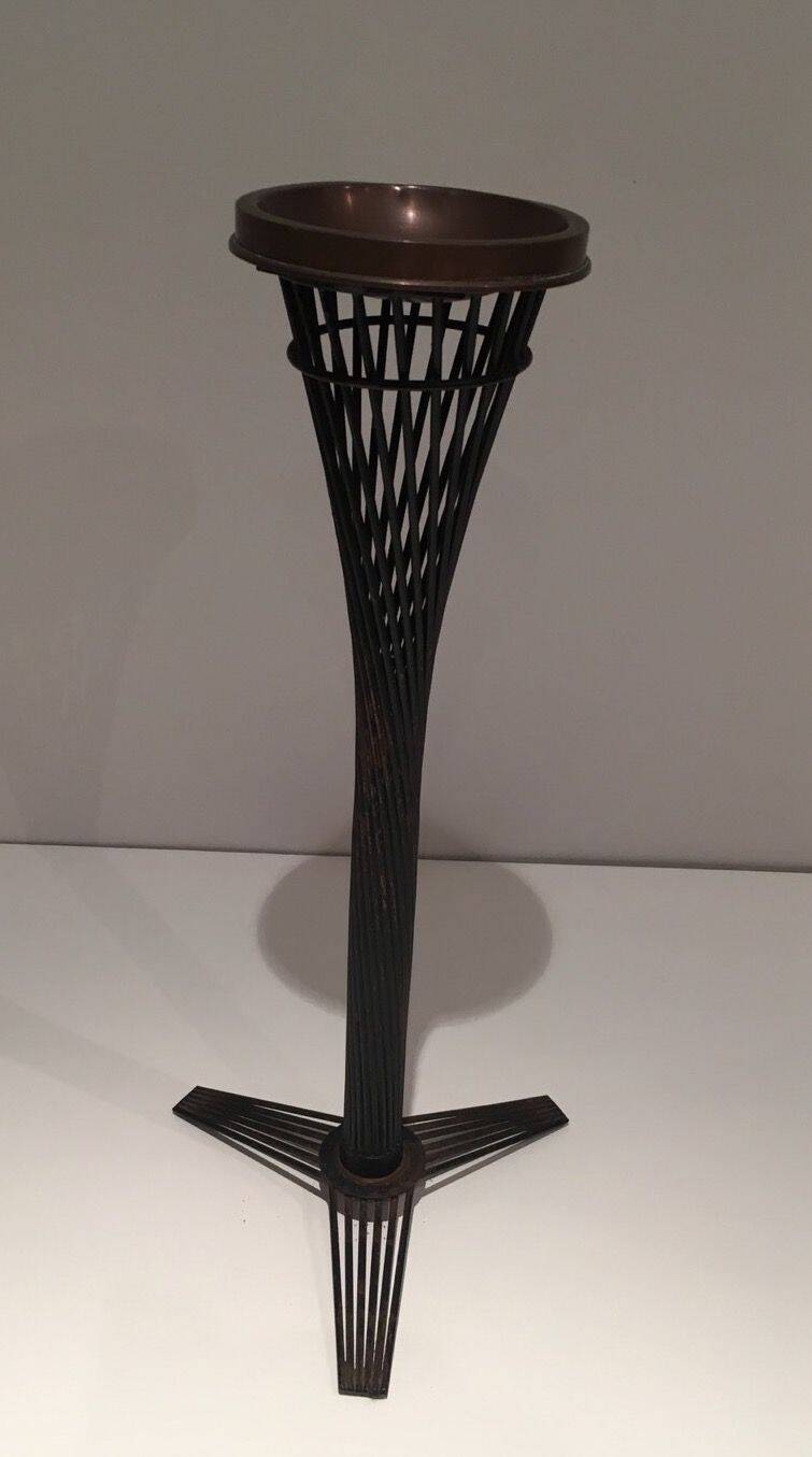 Brass ashtray on a stand made of black lacquered metal wire.