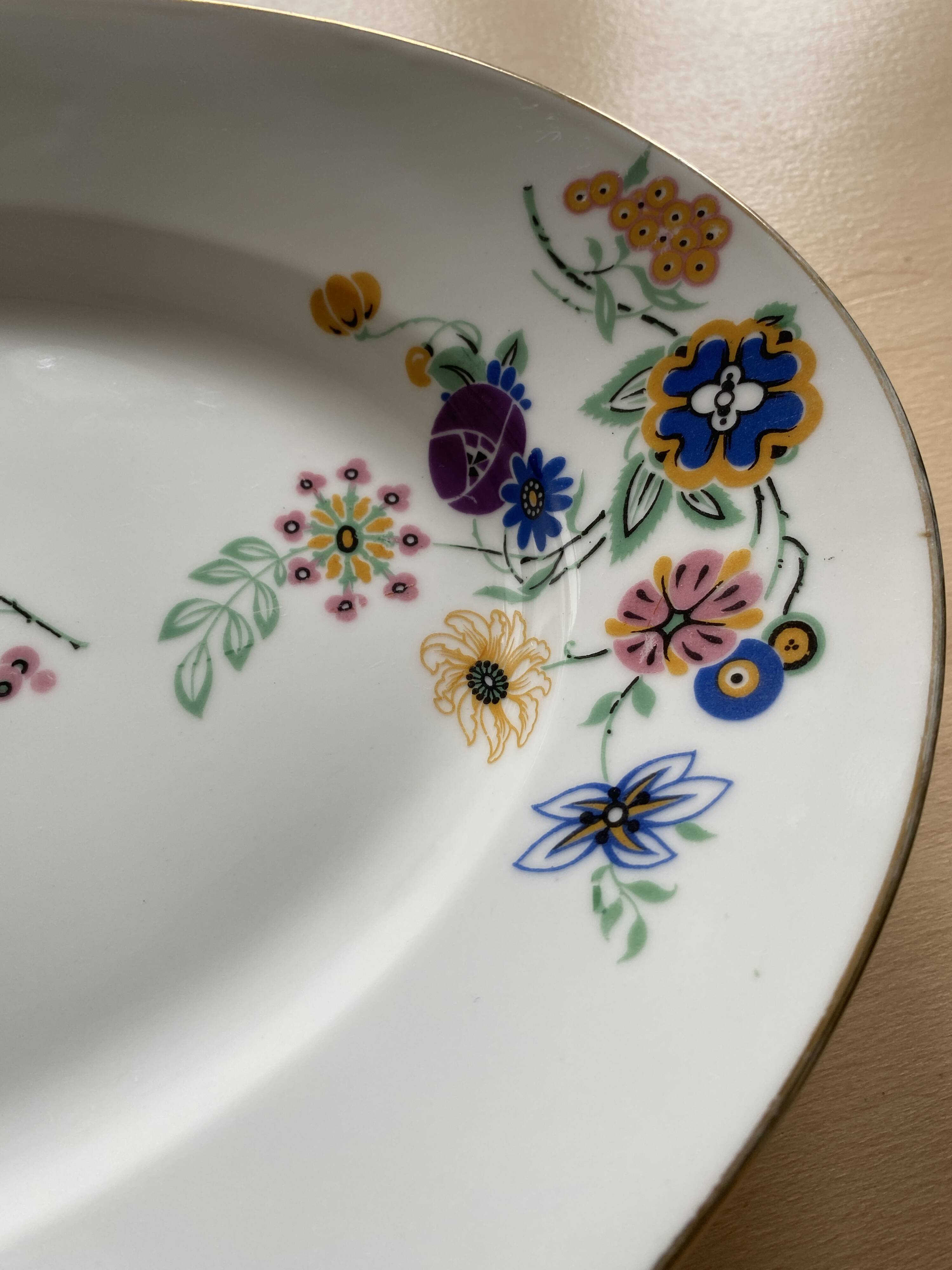 Oval vintage plate in white Limoges porcelain signed T.L.B flowers.