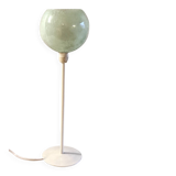 Table lamp with a pale green Clichy glass globe.