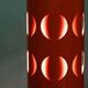 Vintage orange suspension light in a 1970s space age style.