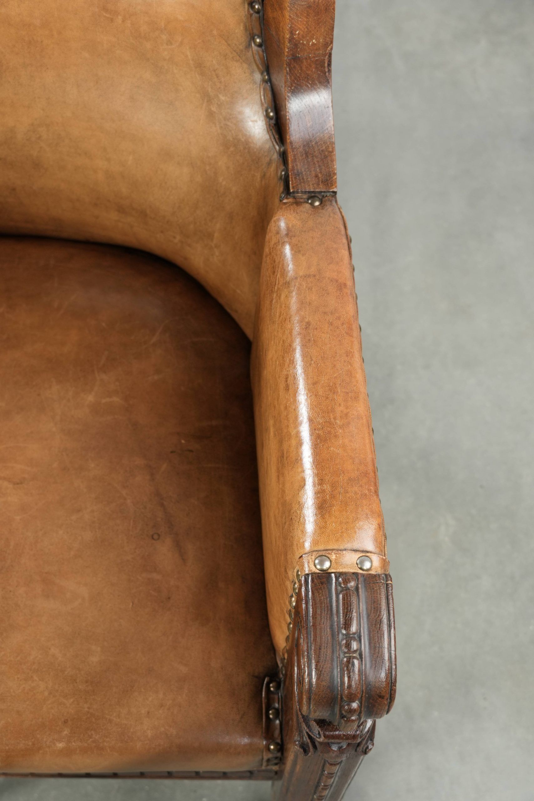 Antique armchair made of sheepskin and wood with decorative nails