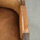 Antique armchair made of sheepskin and wood with decorative nails