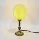 Ostrich egg lamp on a brass stand, antique curiosity cabinet.