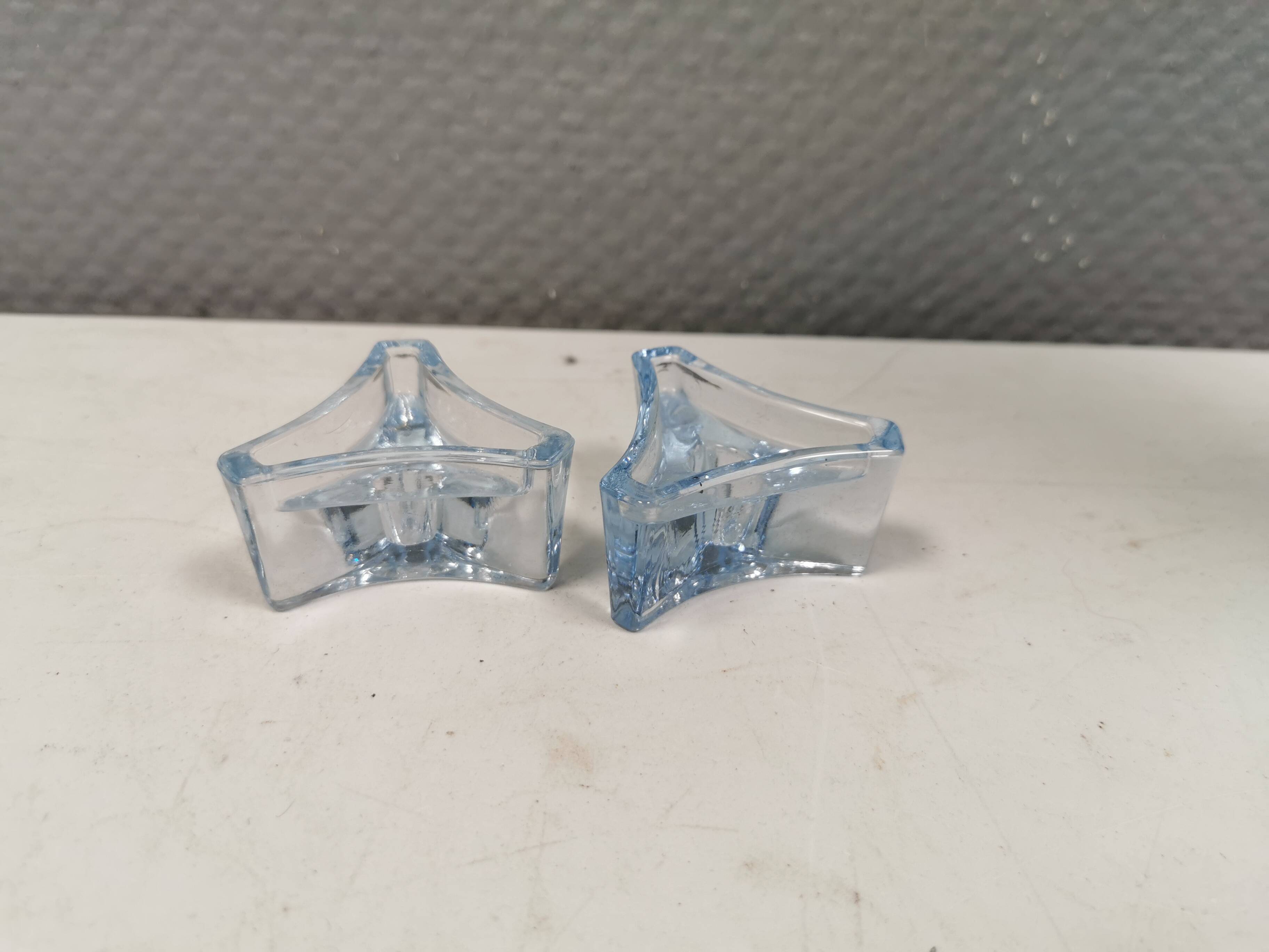 Two beautiful glass candle holders in translucent bluish glass.