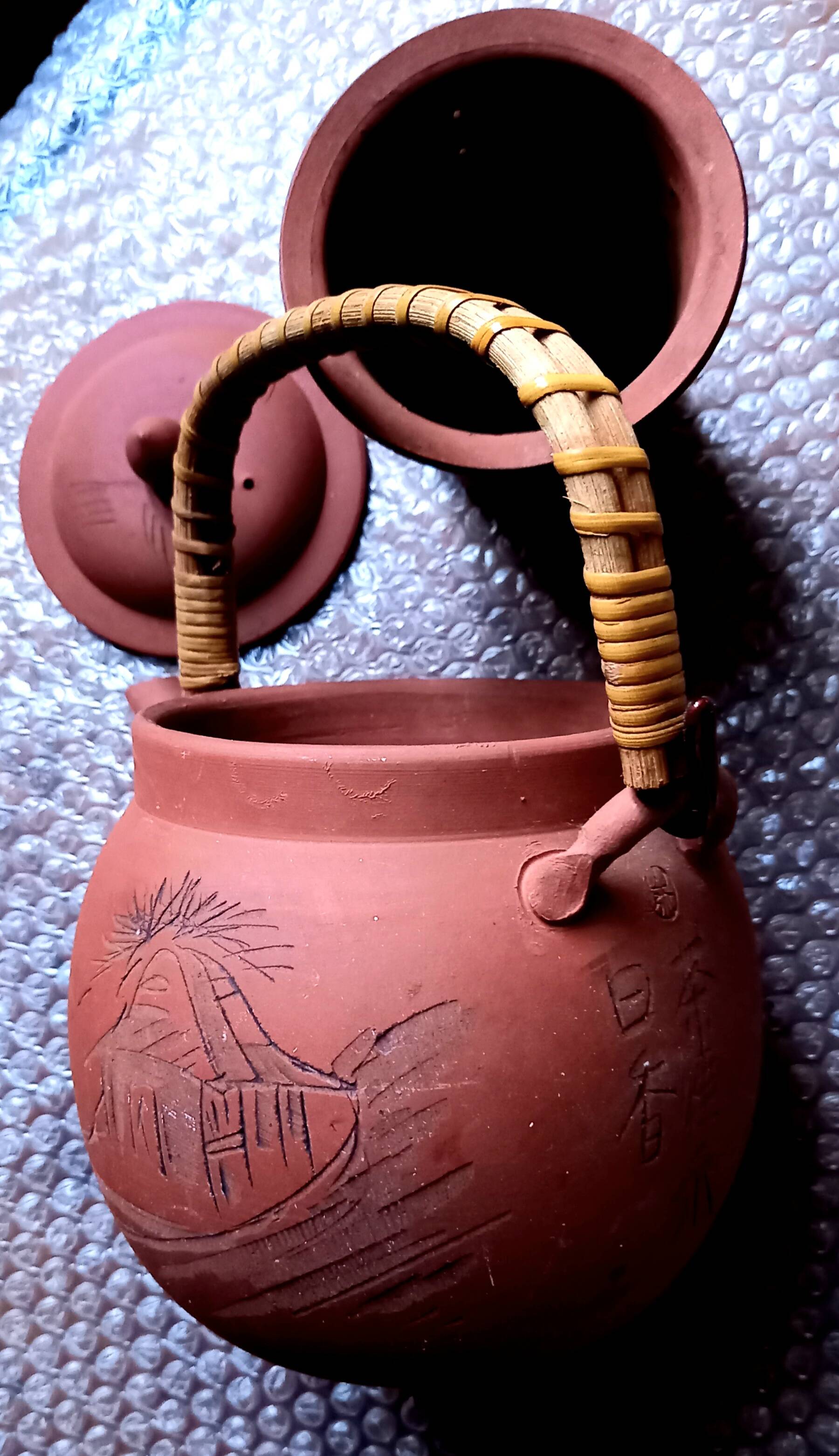 Terracotta and rattan teapot