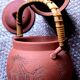 Terracotta and rattan teapot