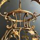 Important golden iron lantern with foliage decorations from the Baguès house.
