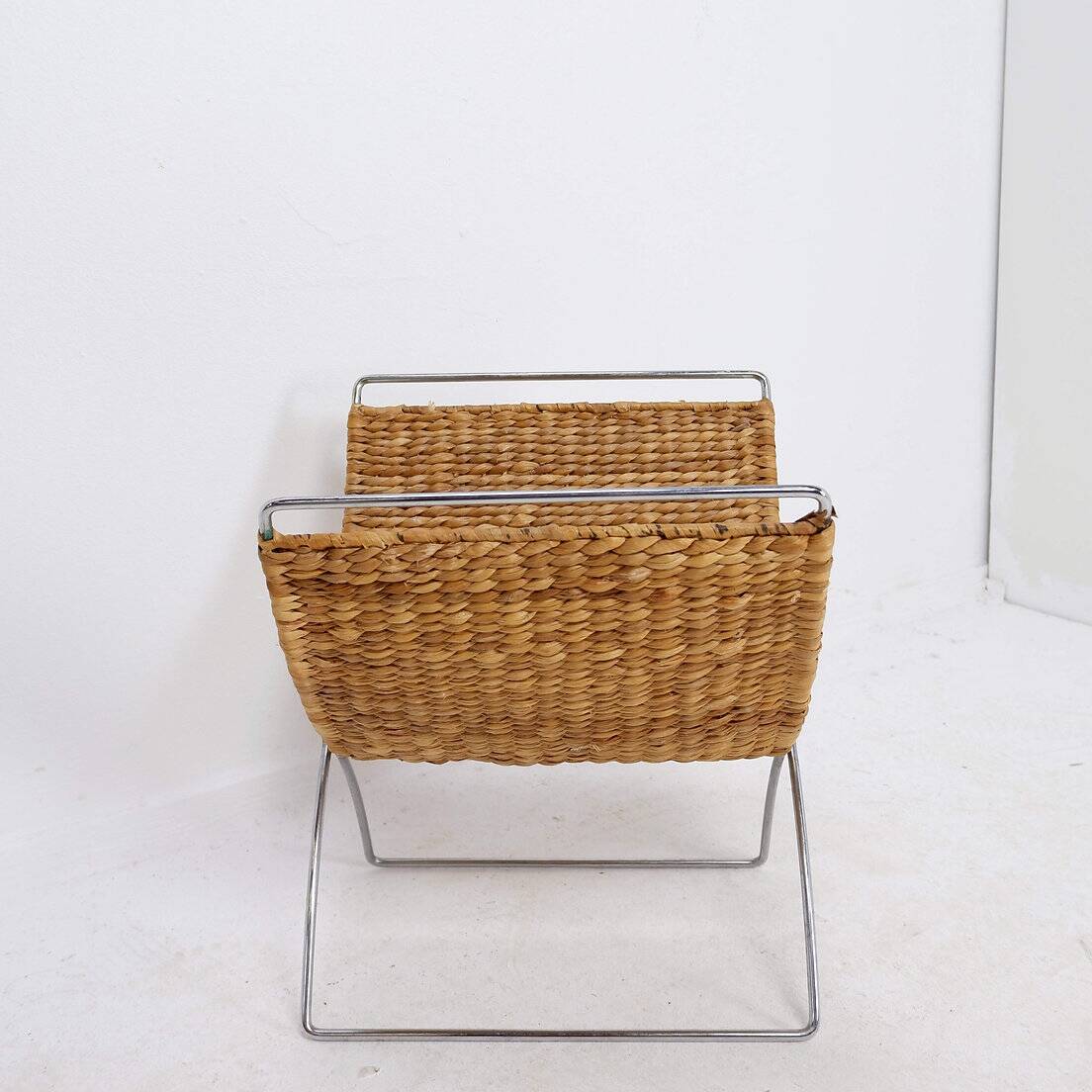 Chrome metal magazine rack with woven banana leaves