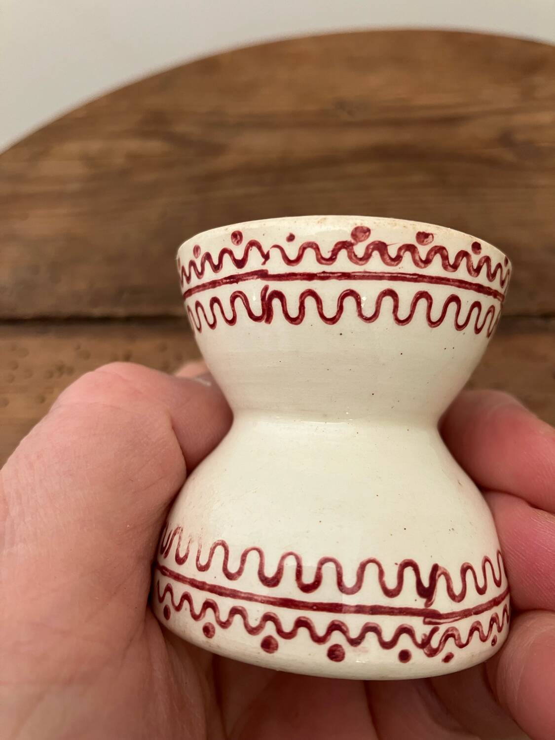 Vintage diabolo-shaped egg cup with burgundy patterns
