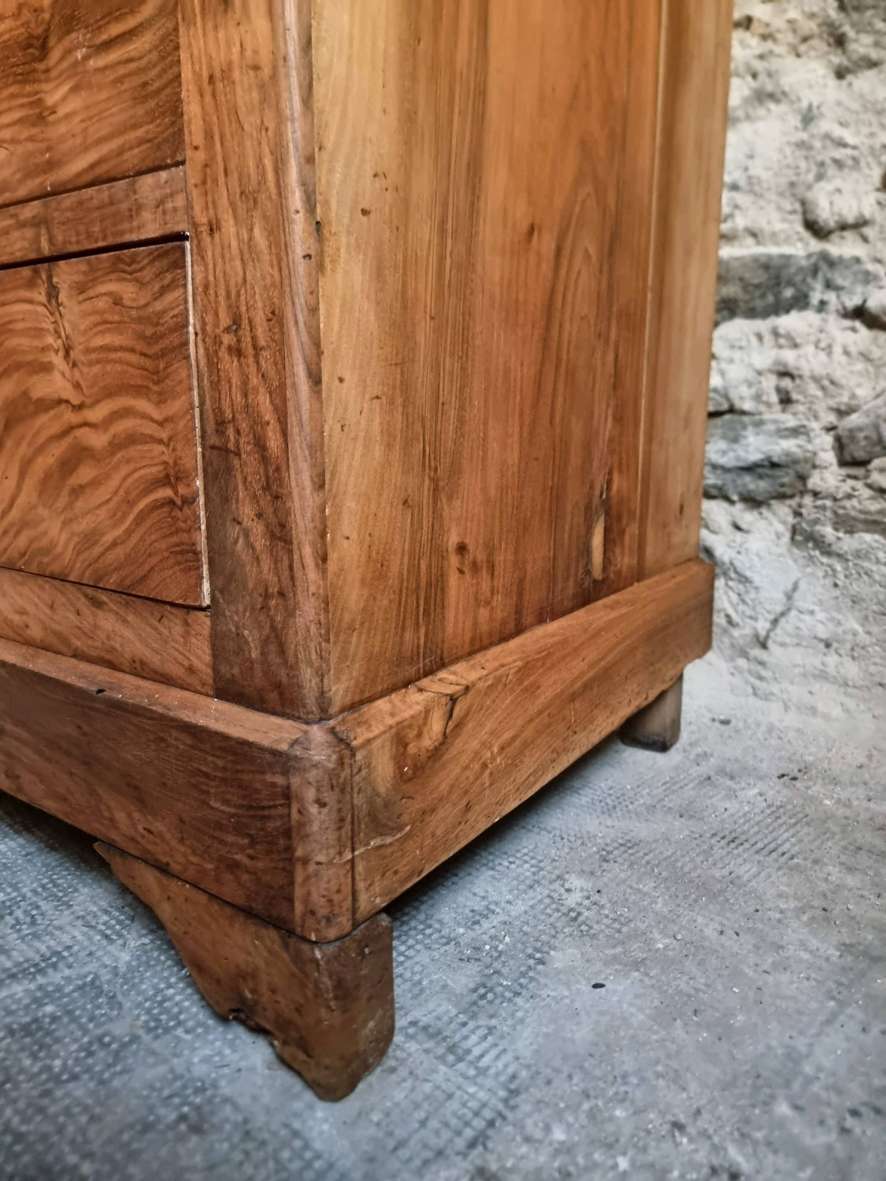 French antique walnut commode with a dark grey marble top, circa 1830–1860.