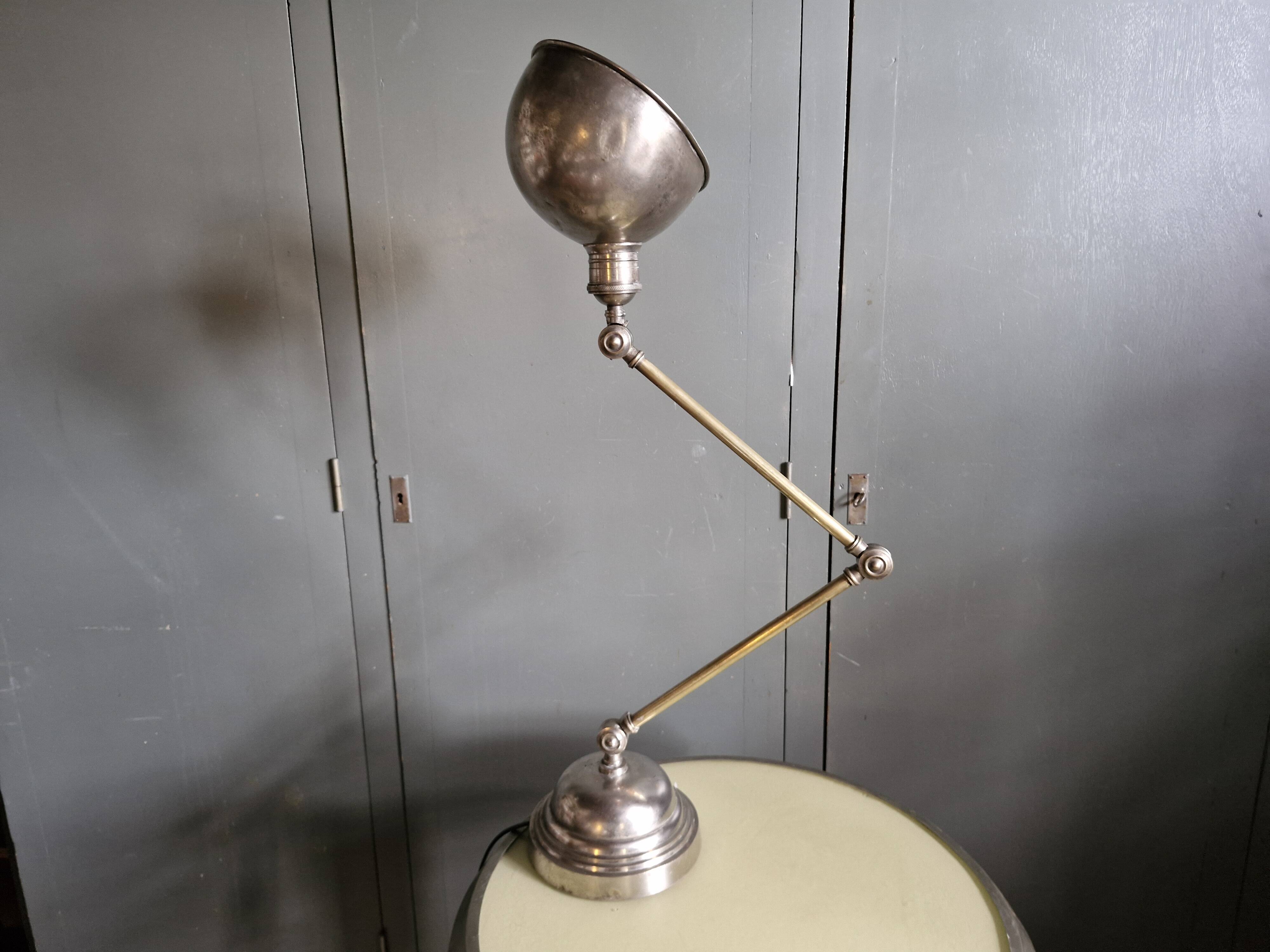 Old adjustable industrial lamp in bronze with 2 arms.