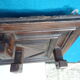 Wall-mounted coat rack in solid oak with 9 hooks.