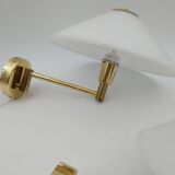 Pair of articulated arm wall lights in brass with opaline globe