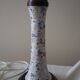 Table lamp for bedside use in earthenware with a wooden base.