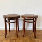 2 antique bistro stools with curved wood and caning effect.
