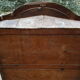 Small solid wooden cabinet with a gendarme hat