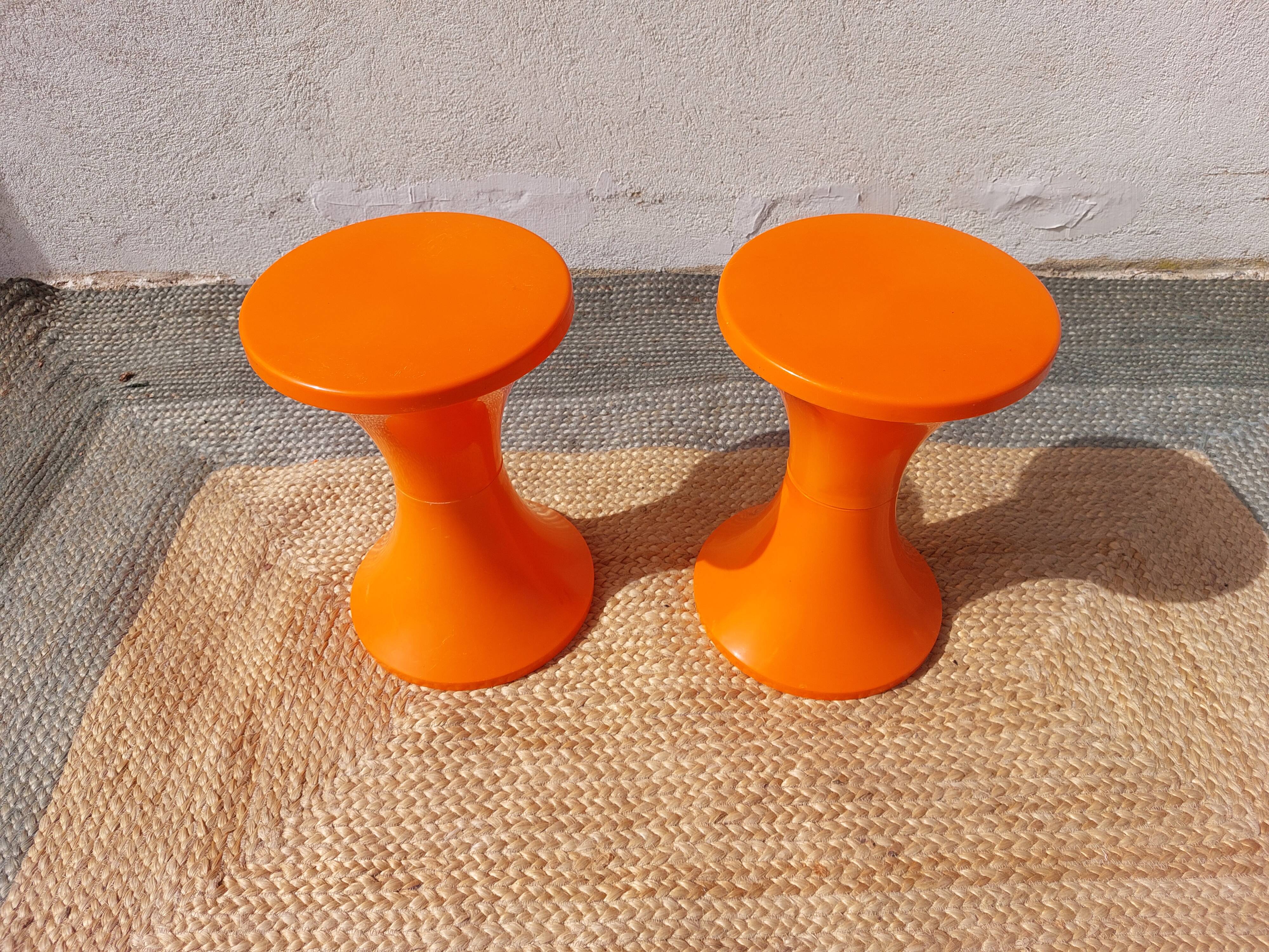 pair of orange tam-tam stools