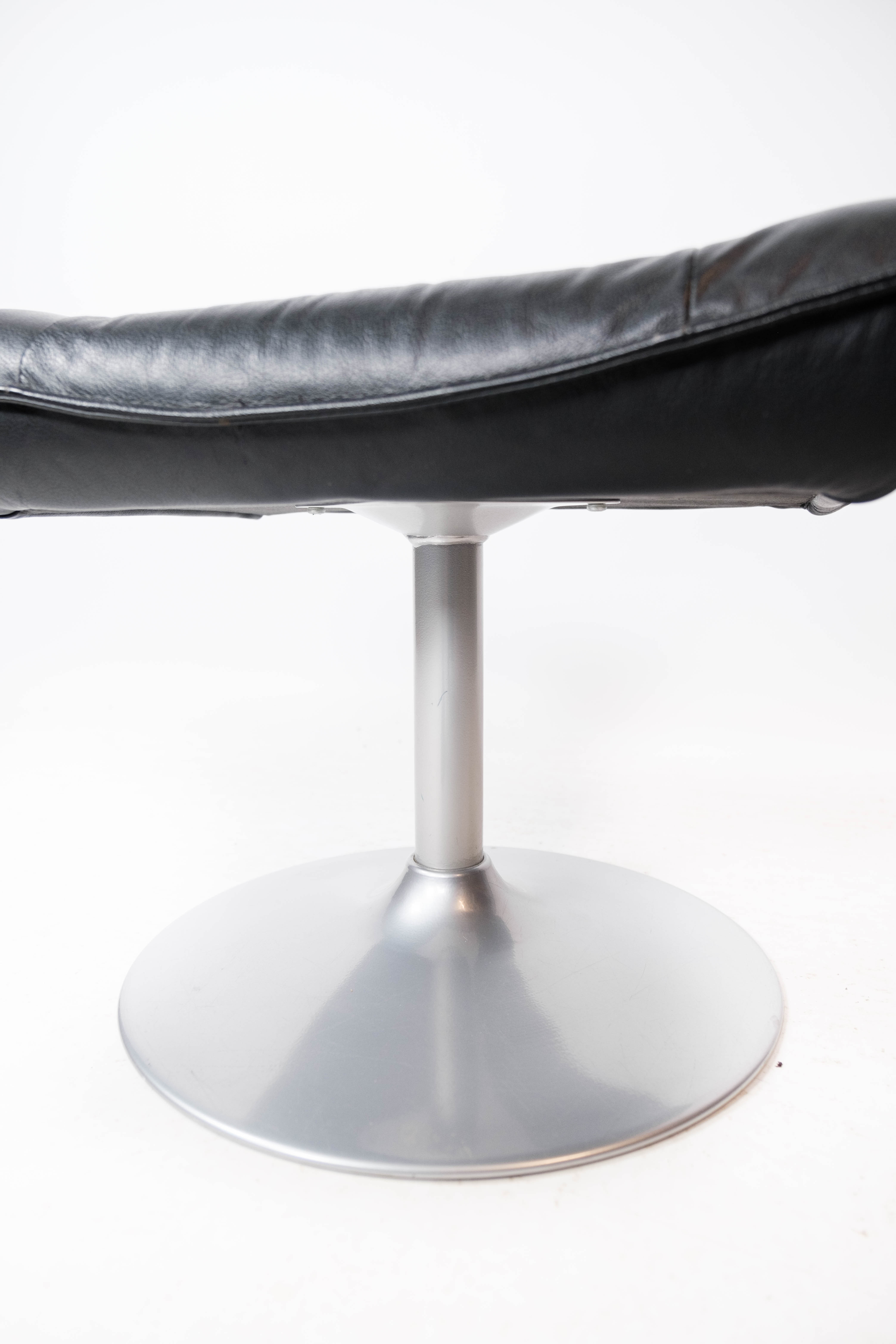 Easy chair with stool upholstered with black leather of Danish design, 1970s