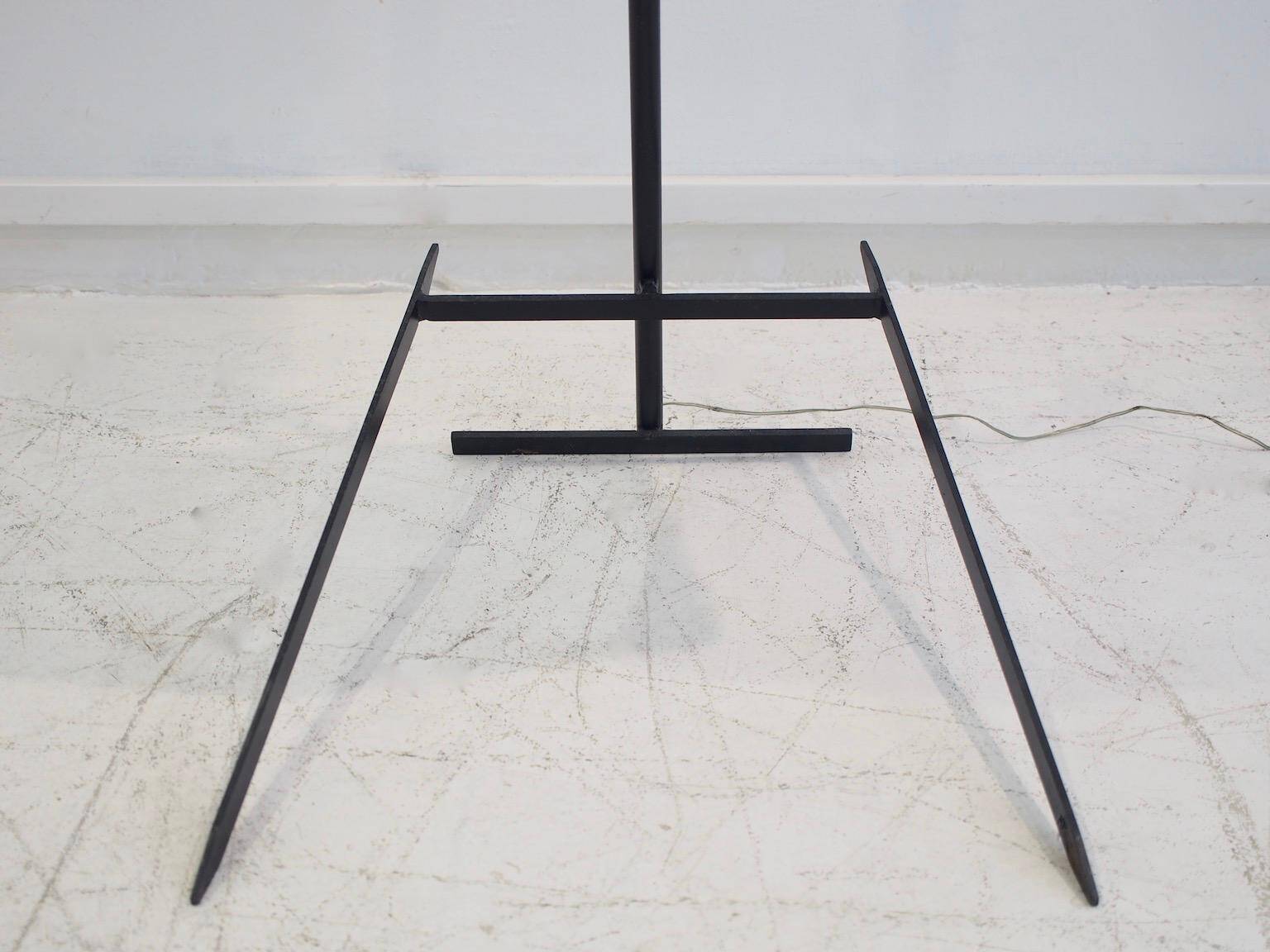 Brass and lacquered metal floor lamp with a wooden magazine shelf.