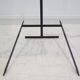 Brass and lacquered metal floor lamp with a wooden magazine shelf.