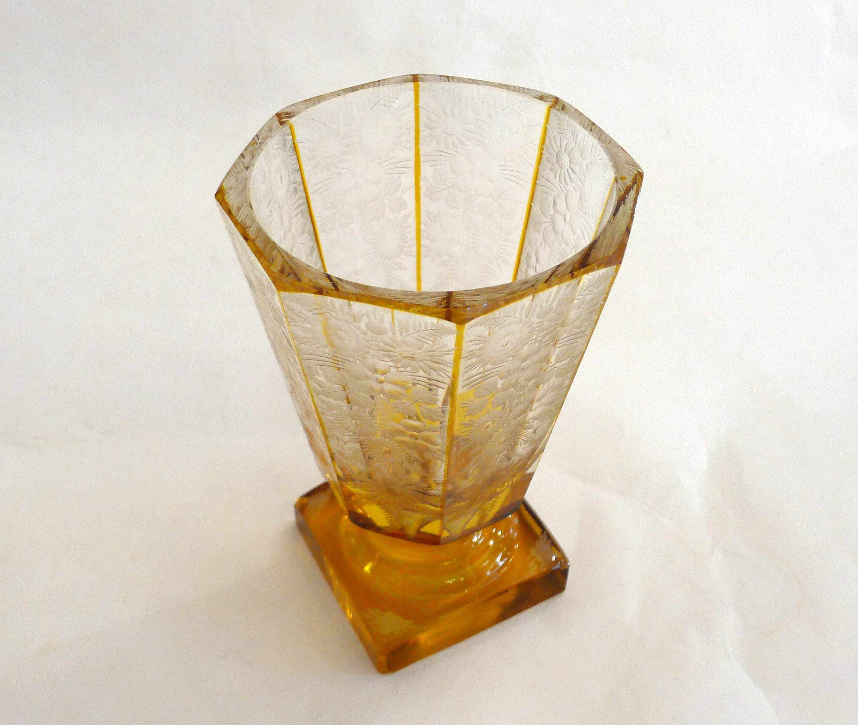 Art Deco vase engraved with flowers, faceted body on a pedestal.