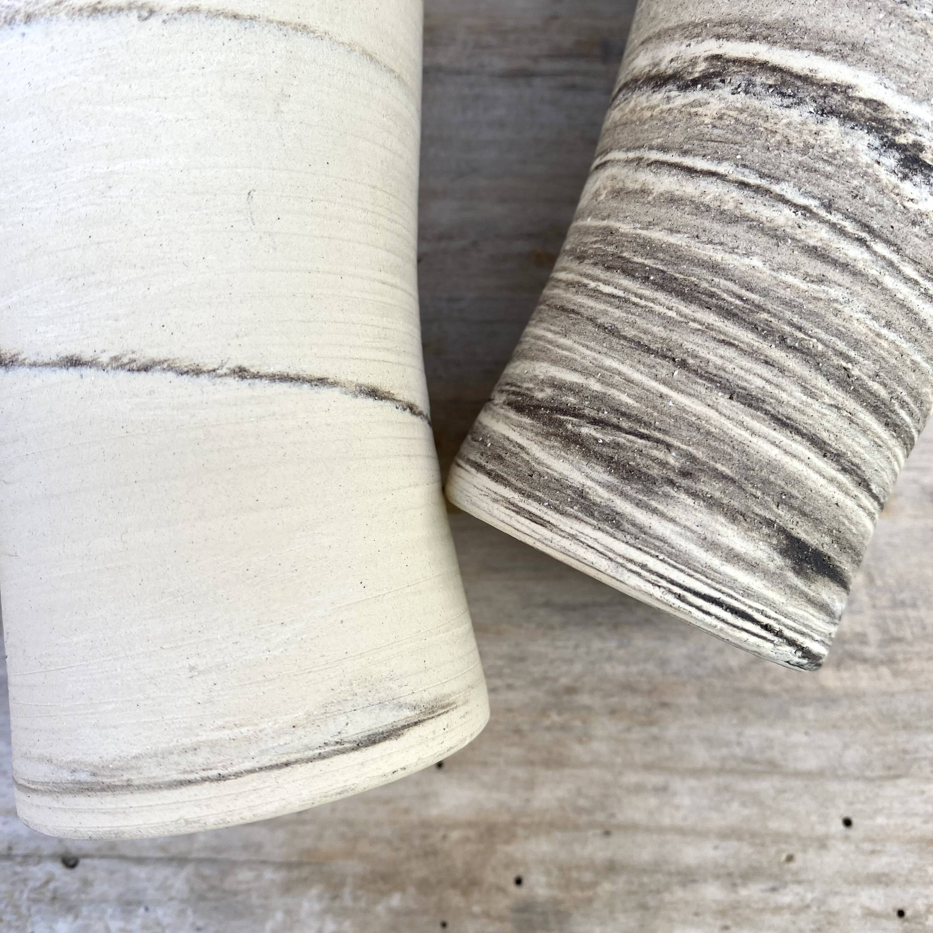 High ceramic cups made of mixed clay.