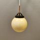 Small Art Deco hanging lamp in cream coloured glass and bakelite top.
