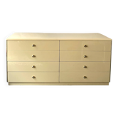 Commode type sideboard with 8 drawers, ivory lacquer and brass details, 1970s design.