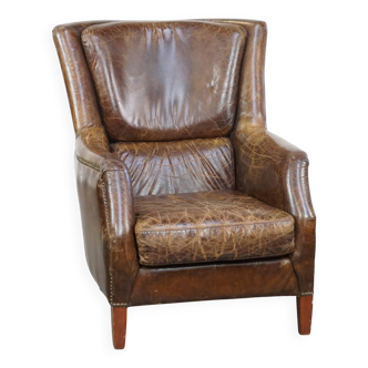 Fauteuil en cuir de vachette grainé au design intemporel
