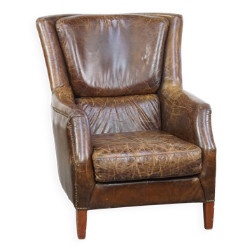 Grained cowhide armchair with a timeless design