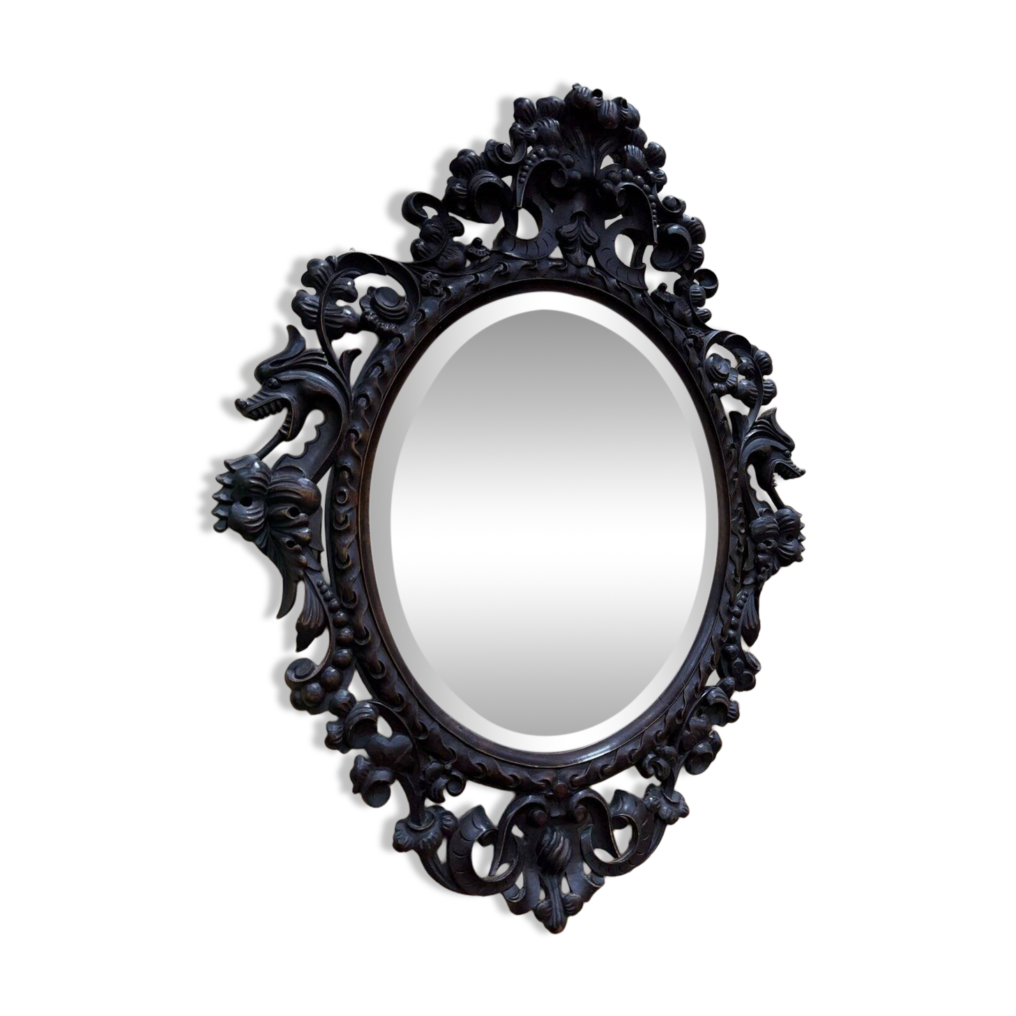 Oval mirror in carved wood with dragon heads.